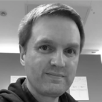 black and white photograph of Dan Copley smiling.