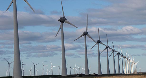 Photo by Distinct Designer on Unsplash, large wind turbine farm.