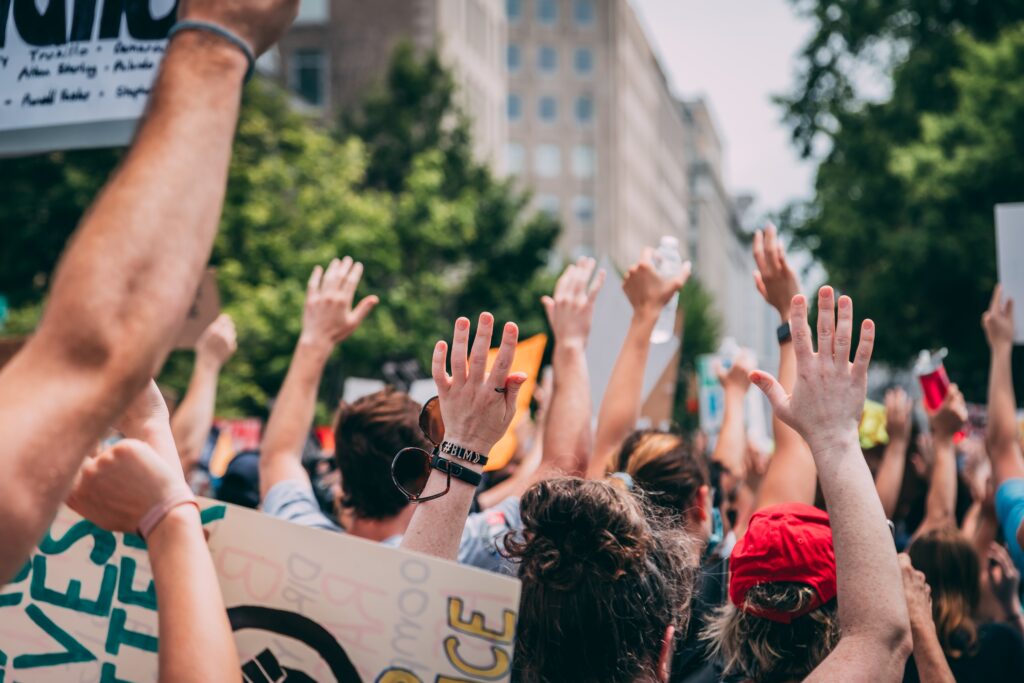 Hands Up in a crowd, pic by Vlad-Tchompalov on Unsplash