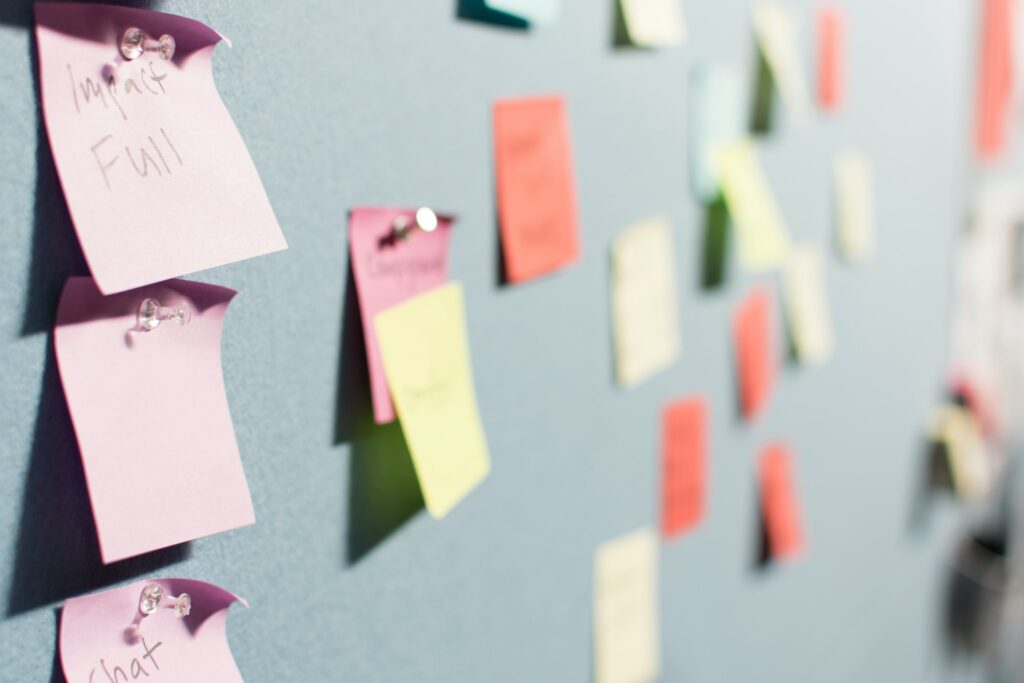 Post it notes on a board, pic by patrick-perkins on unsplash