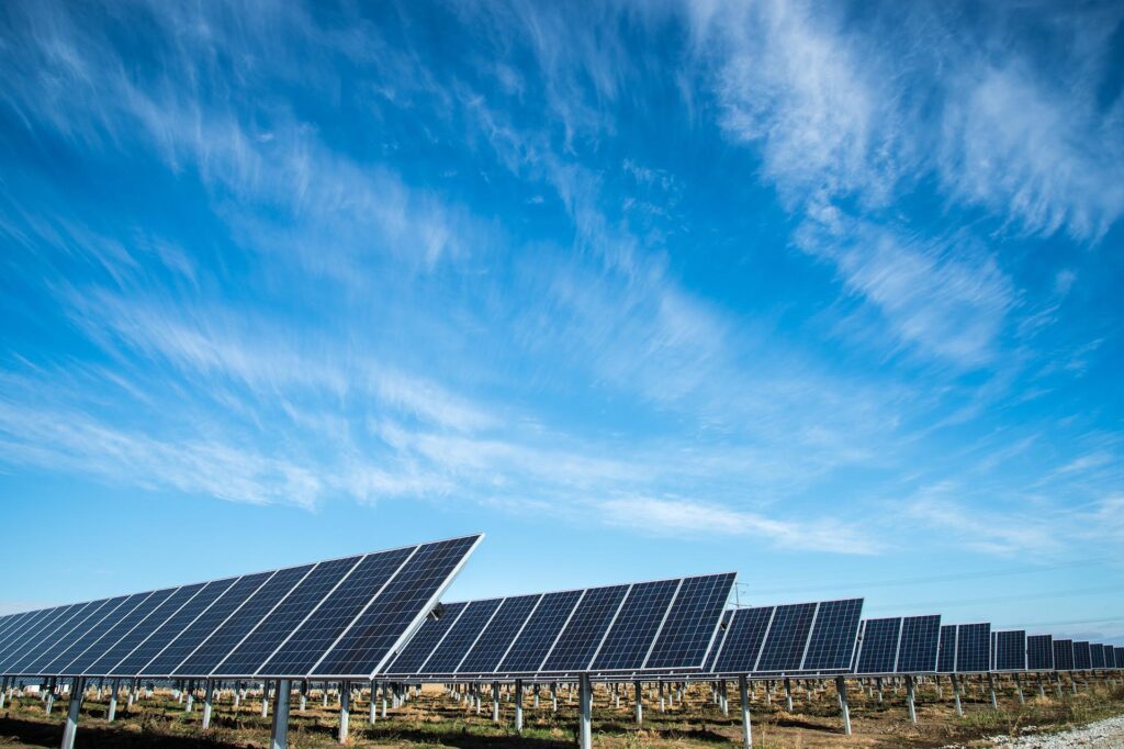 Solar farm panels in a flat field, photo by American Public Power Association on Unsplash