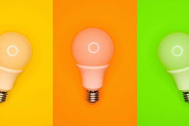 Three light Bulbs set against different coloured backgrounds, orage, green and yellow - pic by Daniele-Franchi on Unsplash
