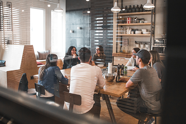 Photo by Redd F on Unsplash, seven people gathering in a informal environment for a meeting