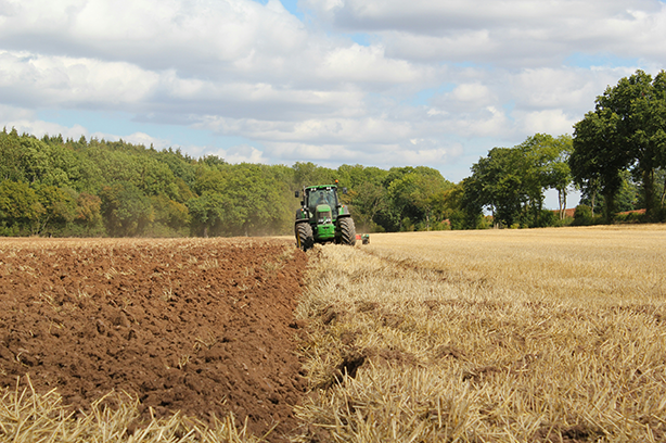 Photo by Richard Bell on Unsplash, tractor ploughing a field
