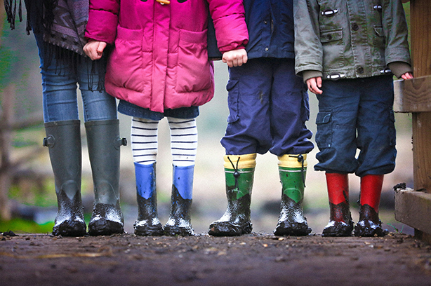 Photo by Ben Wicks on Unsplash, four sets of kids legs all wearing muddy wellies