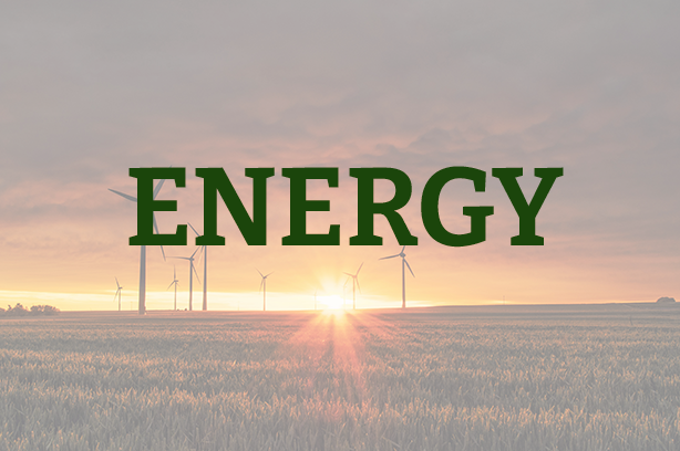 Photo by Karsten Würth on Unsplash, wind turbines in a field during sunrise, with 'energy' written over the top