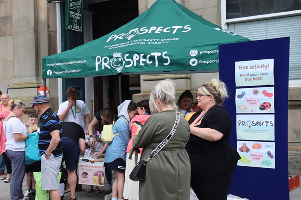 People milling around a stall at Accrington EcoFest for Prospects