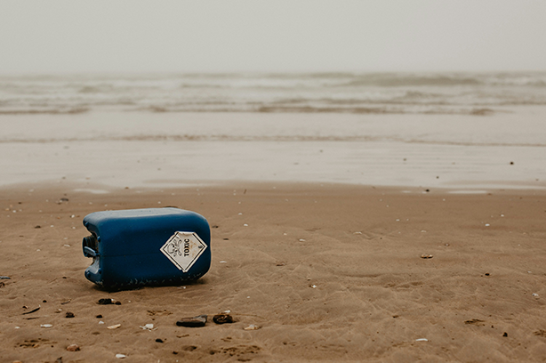 Photo by Beth Jnr on Unsplash, washed up toxic litter on a beautiful beach.