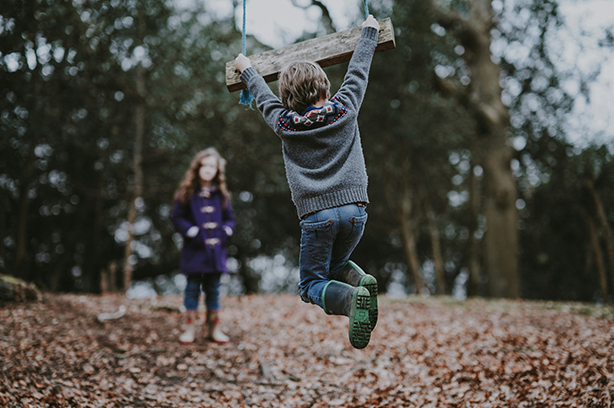 Photo by Annie Spratt on Unsplash, children playing on tree swing in woods