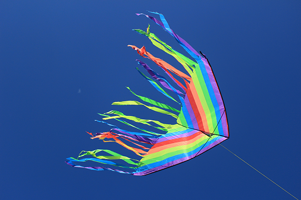 Photo by Lucie Hošová on Unsplash, flying multicoloured kite