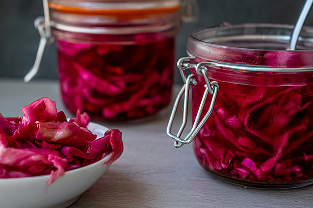 Photo by The Matter of Food on Unsplash, red pickled cabbage in clamp lid jars