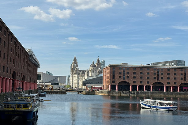 Photo by Chris Porter on Unsplash, Royal Liver Building seen in the distance from the Albert Dock and waterfront, Liverpool.