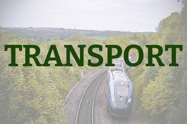 Photo by Umair D on Unsplash, a high-speed transpennine express train passing through foliage, word 'transport' in the foreground
