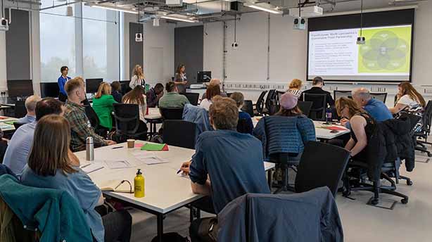 Food workshop, attendees listening and watching a slide show for the food presentation
