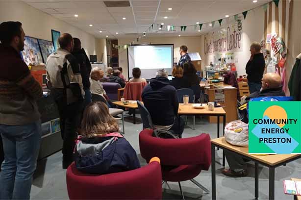 Community Energy Preston group sitting in a room in front of a large screen