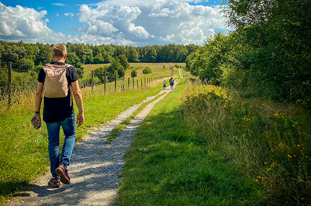 Photo by Jennifer Latuperisa-Andresen on Unsplash, walkers on a country path in the sunshine