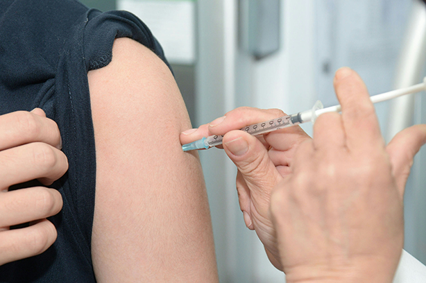 Photo by Hyttalo Souza on Unsplash, injection being administered