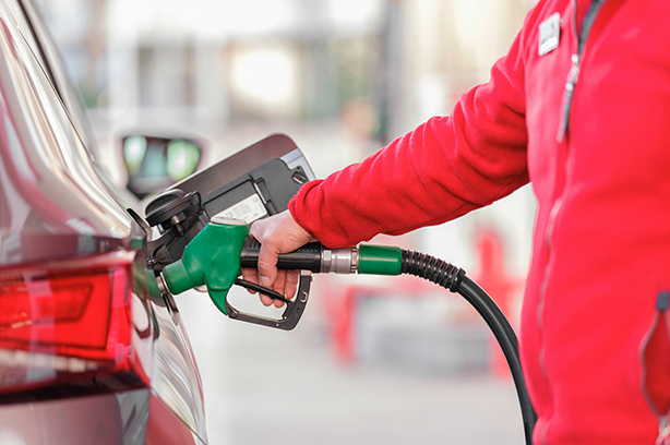 Photo by engin akyurt on Unsplash, closeup of man pumping petrol into a car at a fuel station