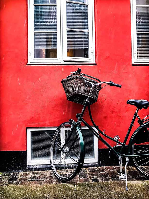 Bicycle lent against a red house in Copenhagen