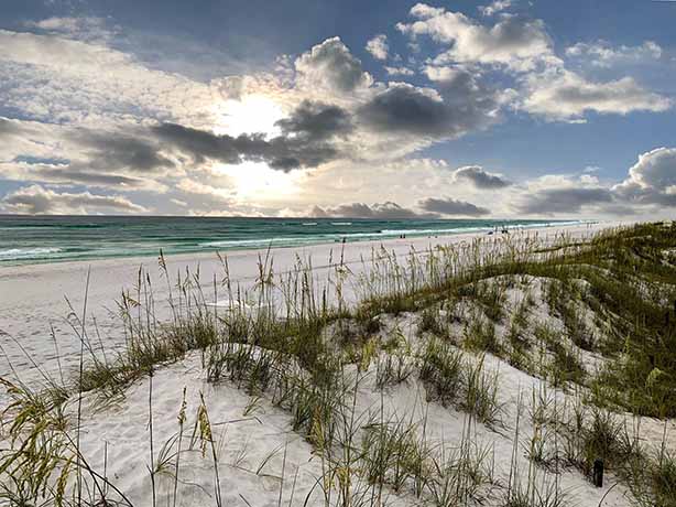 clouded coast with sand dunes in the foreground