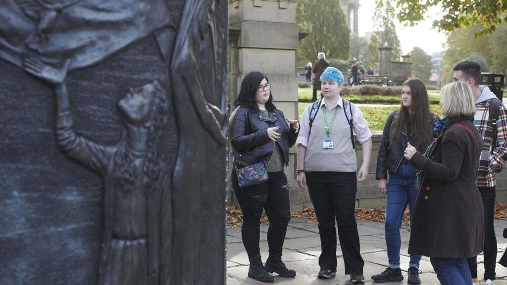 Students studying BA (Hons) in Religion looking at memorials on a fieldtrip to Liverpool