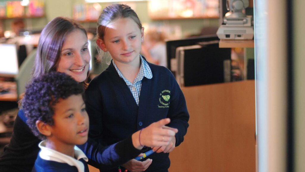 Two primary school students and their tutor