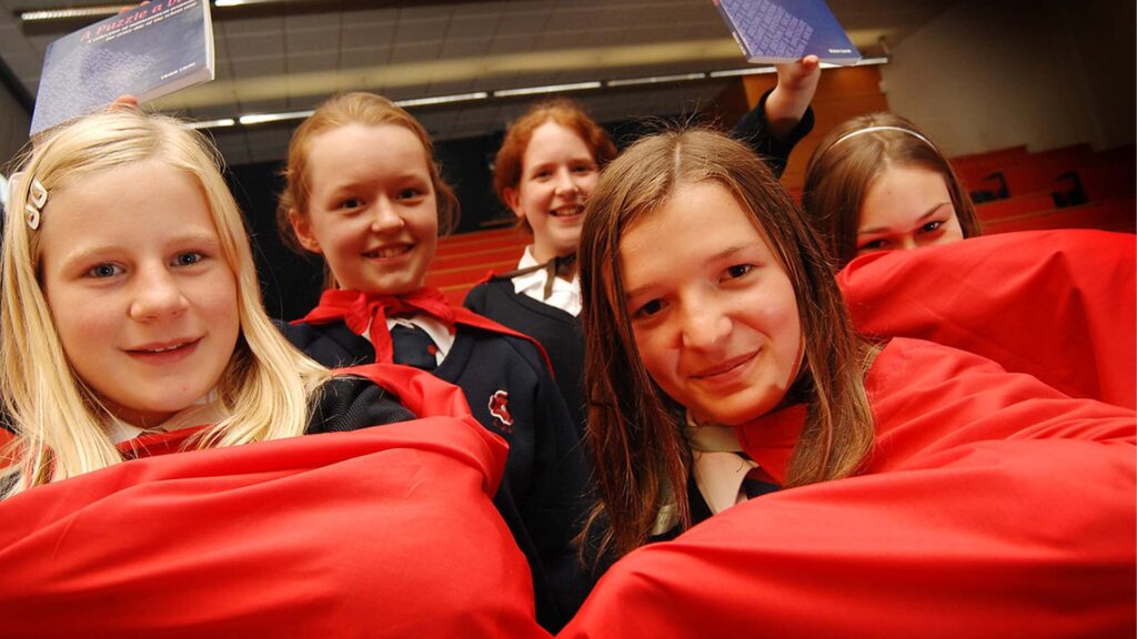 Five secondary maths students smile to camera