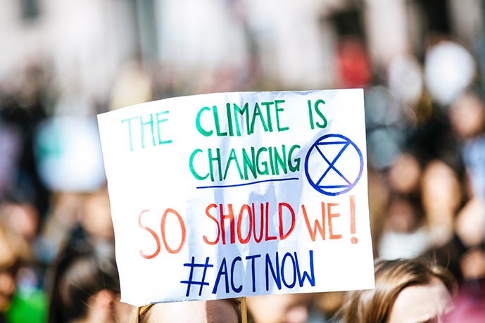 Homemade poster 'The climate is changing' being held at a demonstration