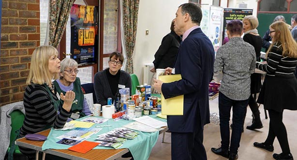 Mark Allanson talking to staff at the foodbank stall