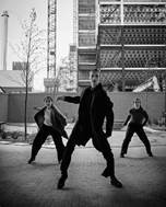 Tread Lightly on the Planet, black and white image of three performers outside