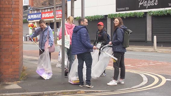 Students from the local community litter picking on Wavertree High Street in Liverpool