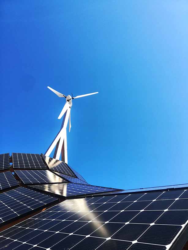 Solar farm and a wind turbine, Photo by Nazrin B-va on Unsplash