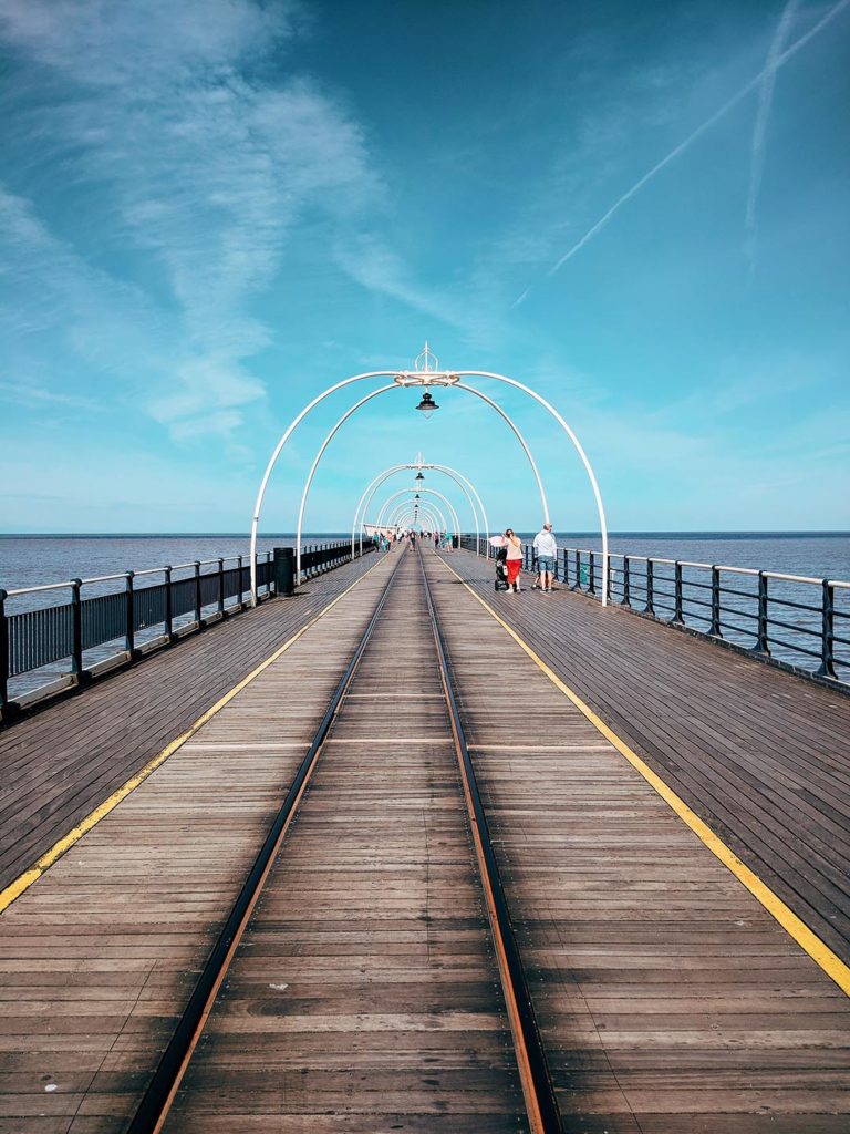 People walking along Southport Pier