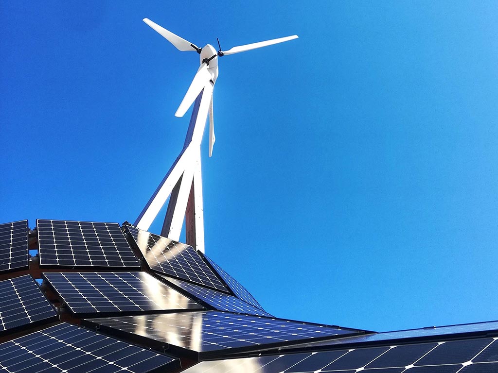 Solar panels with a small wind turbine behind