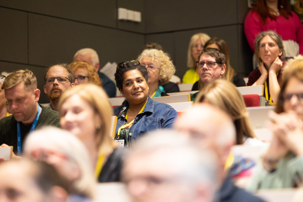 People listening to a presentation in a lecture theatre at the first Lancashire Community Climate Action Forum