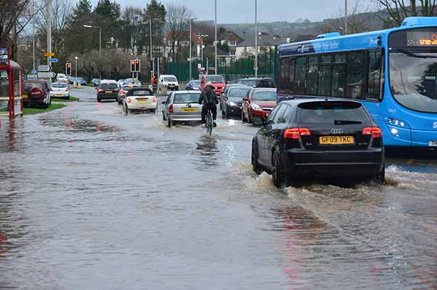 Photo by Chris Gallagher on Unsplash, river bursts its banks causing flooding in Bingley