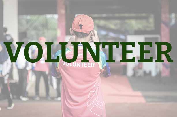 Photo by ray sangga kusuma on Unsplash, voluteer taking a photograph, word 'volunteer' in the foreground