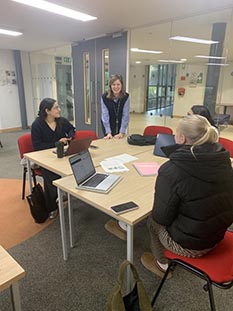 Catherine discussing ideas with final year Social Marketing students at the briefing event on campus.