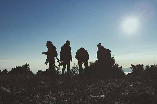 Photo by Filip Filkovic Philatz on Unsplash, silhouette of four men standing near green plants