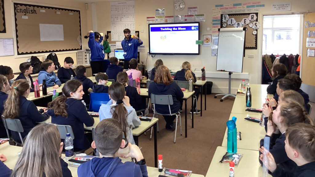 Conor Gibson mentoring a class of primary school students