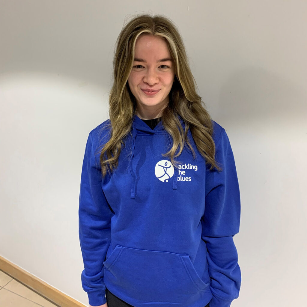 Mia Kennedy in a blue Tackling the Blues hoody