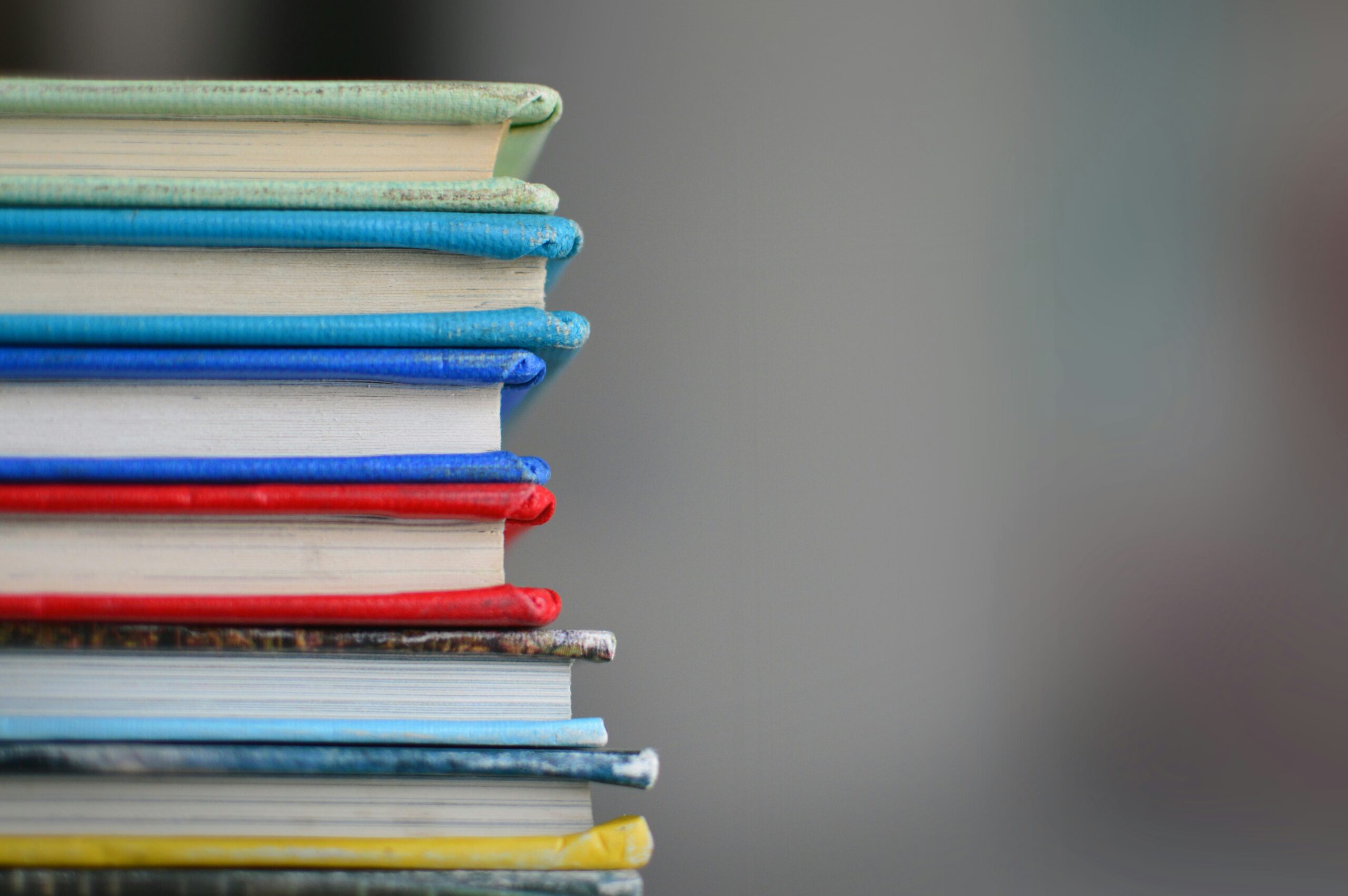 Seven books with colourful covers stacked on top of each other. Image for decorative purposes only.
Photo by Kimberly Farmer on Unsplash